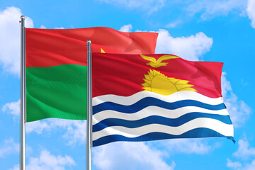 Kiribati and Burkina Faso national flag waving in the windy deep blue sky. Diplomacy and international relations concept.