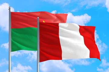 Peru and Burkina Faso national flag waving in the windy deep blue sky. Diplomacy and international relations concept.