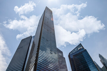 Fototapeta na wymiar office buildings. Looking Up At Modern Corporate Buildings On A Sunny Day, With Dramatic Clouds, In Singapore. Stock Photo..