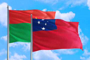 Fototapeta na wymiar Samoa and Burkina Faso national flag waving in the windy deep blue sky. Diplomacy and international relations concept.