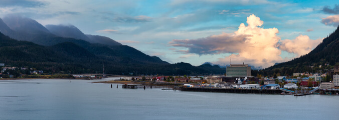 Beautiful Panoramic view of a small town, Juneau, with mountains in the background. Colorful Sunrise Sky. Taken in Alaska, United States.