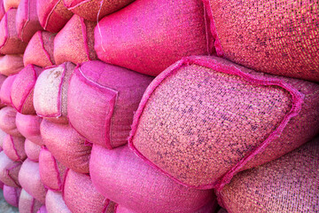 Obraz na płótnie Canvas Coffee beans in pink sack bags at storage house