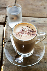 Hot mocha in glass cup on wooden table
