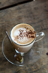 Hot mocha in glass cup on wooden table