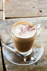 Hot mocha in glass cup on wooden table