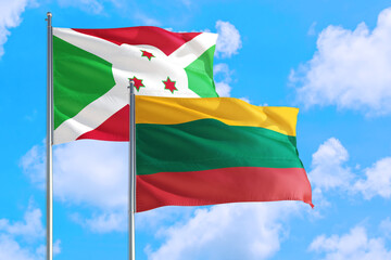 Lithuania and Burundi national flag waving in the windy deep blue sky. Diplomacy and international relations concept.