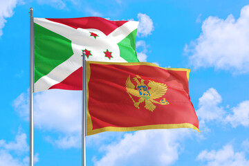 Montenegro and Burundi national flag waving in the windy deep blue sky. Diplomacy and international relations concept.
