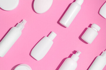 Mock up pattern for branding on pink background. Tubes, dispensers and jars. Cosmetics and dietary supplements for beauty and health. Flat lay