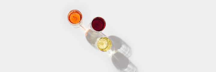 Set of wine in glasses with beautiful shadows. anner with red, rose and white wine