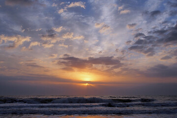 Colorful orange and blue sunrise over ocean on St Augustine Beach, Florida.