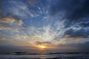Colorful orange and blue sunrise over ocean on St Augustine Beach, Florida.