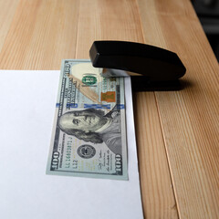 The paper money is pinned the document. Concept.