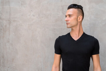 Portrait of handsome young Italian man with undercut wearing black t-shirt and thinking