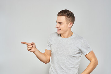 handsome man in light t-shirt cropped view emotion studio isolated background