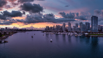 Naklejka premium False Creek, Vancouver, British Columbia, Canada. Aerial Panoramic View of a Modern Downtown City View. Dramatic Colorful Sunset Sky.