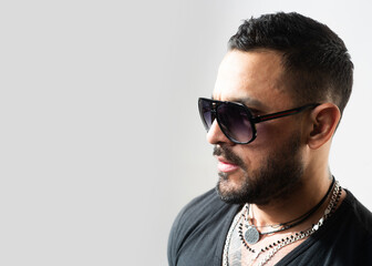 Fototapeta premium Studio shot of young man with sunglasses. Handsome guy with confident face.