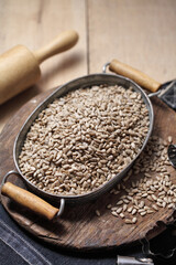 sunflower seeds in iron tray on rustic background