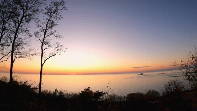 Lake Huron sunset over water where a bulk carrier ship leaving Goderich Salt Mine, the largest salt mining operation site in the world