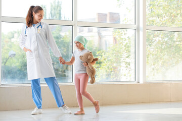 Doctor and little girl in clinic. Childhood cancer awareness concept