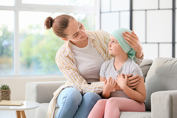 Little girl after chemotherapy with her mother at home