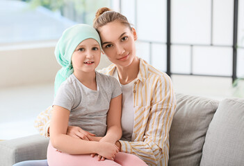 Little girl after chemotherapy with her mother at home