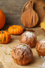 Tasty pumpkin muffins on table