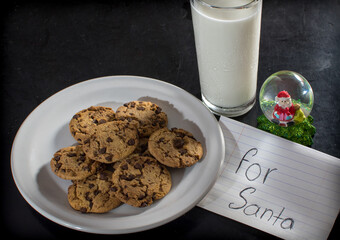 Chocolate chip cookies for Santa Claus with a glass of milk in an overhead shot