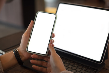 Mock up. image of woman holding mobile phone with blank white screen.