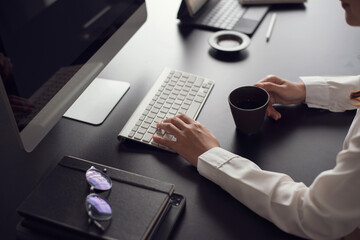 Close up. Woman office worker typing on the keyboard on desk office.