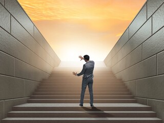 Businessman climbing up challenging career ladder in business co