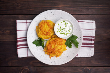 Fried cakes of grated potatoes on the plate with sauce. Traditional pancakes boxty raggmunk.