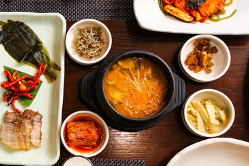 Top view image of Tofu stew and boiled pork meat at Korean traditional full course set meal with...
