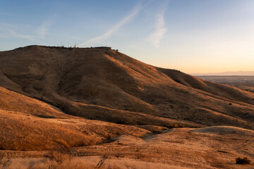 Fototapeta na wymiar The setting sun shines on Table Rock mountain near Boise, Idaho.
