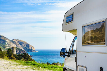 Camper on seaside cliff, Spain