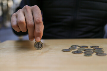 man spinning money on wooden table.