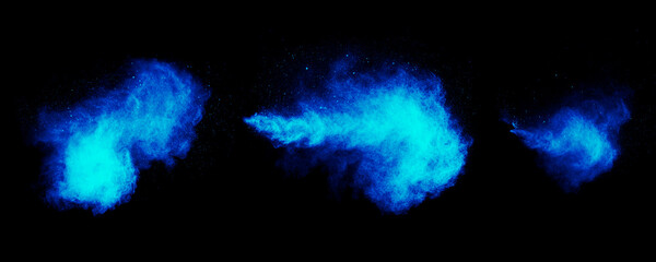 Fototapeta na wymiar Blue clouds of steam. Powder explosion. Abstract blue paint dust isolated on black background