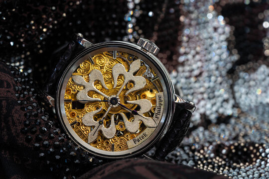 Antique Patek Philippe watch with glitter background.