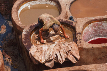 Unknown woker in the tannery in Fez, Morocco. The tanning industry in the city is considered one of...