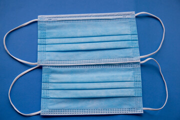 antibacterial medical mask of blue color on a blue background virus epidemic coronavirus protection