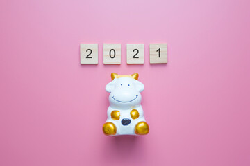 Number 2021 and the bull is a symbol of the New year 2021, on pink background