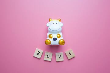 Number 2021 and the bull is a symbol of the New year 2021, on pink background