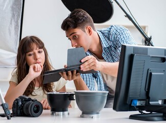 Young photographer working in photo studio