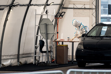 Mobile testing station tent, hot spot for swab test during Coronavirus or COVID19 outbreak with paramedic and car