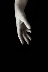 A beautiful female hand stretches your product on a black isolated background, concept art 