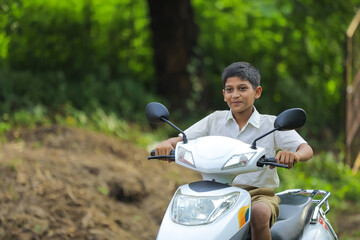 indian little child riding motor bike