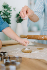 Mother and daughter preparing christmas cookies, tree shape