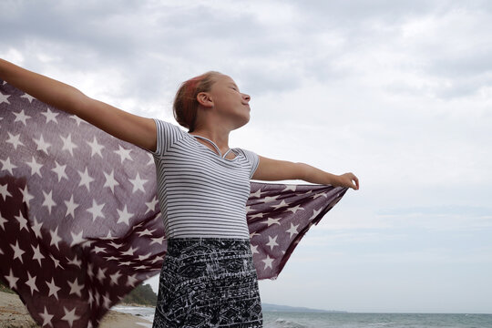 teenage girl with a handkerchief fluttering in the wind in her hands