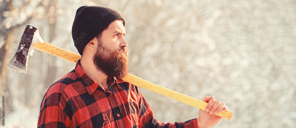 Wall mural lumberjack with an ax in his hands. male holds an ax on a shoulder. brutal bearded man. bearded lumb