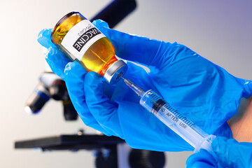 Covid-19 vaccine bottle with a syringe taking the vaccine from it