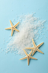 Stack of salt and sea stars on blue background